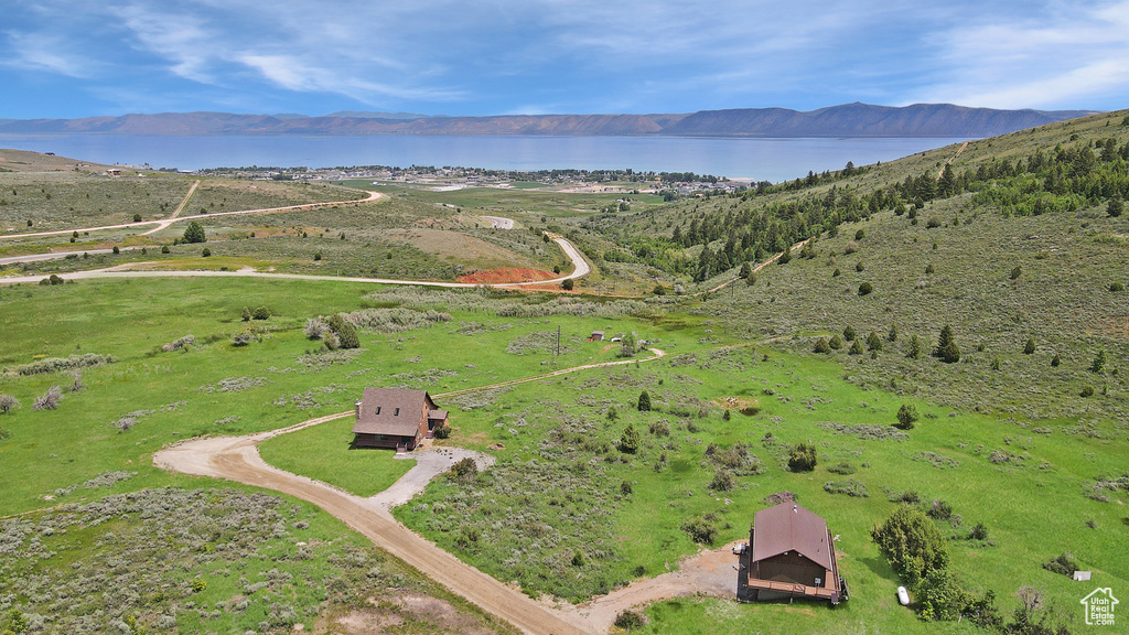 Aerial view of property's location featuring a water and mountain view