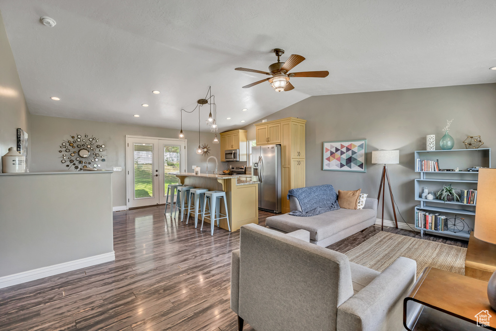 Living room featuring a ceiling fan, dark wood finished floors, recessed lighting, and lofted ceiling