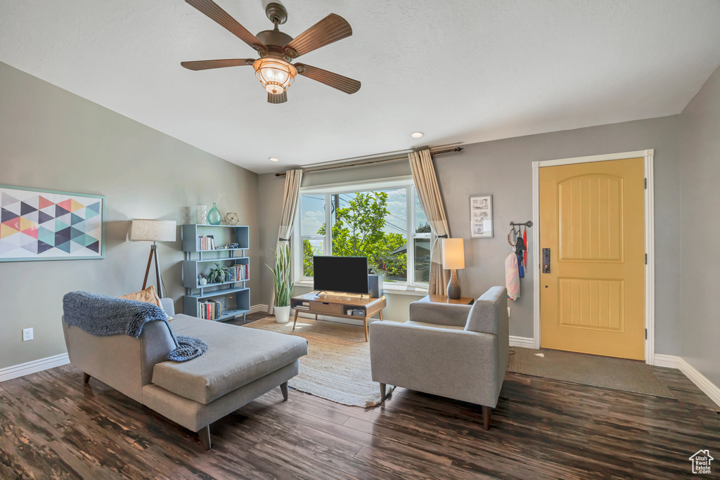 Living area featuring wood finished floors, a ceiling fan, and recessed lighting