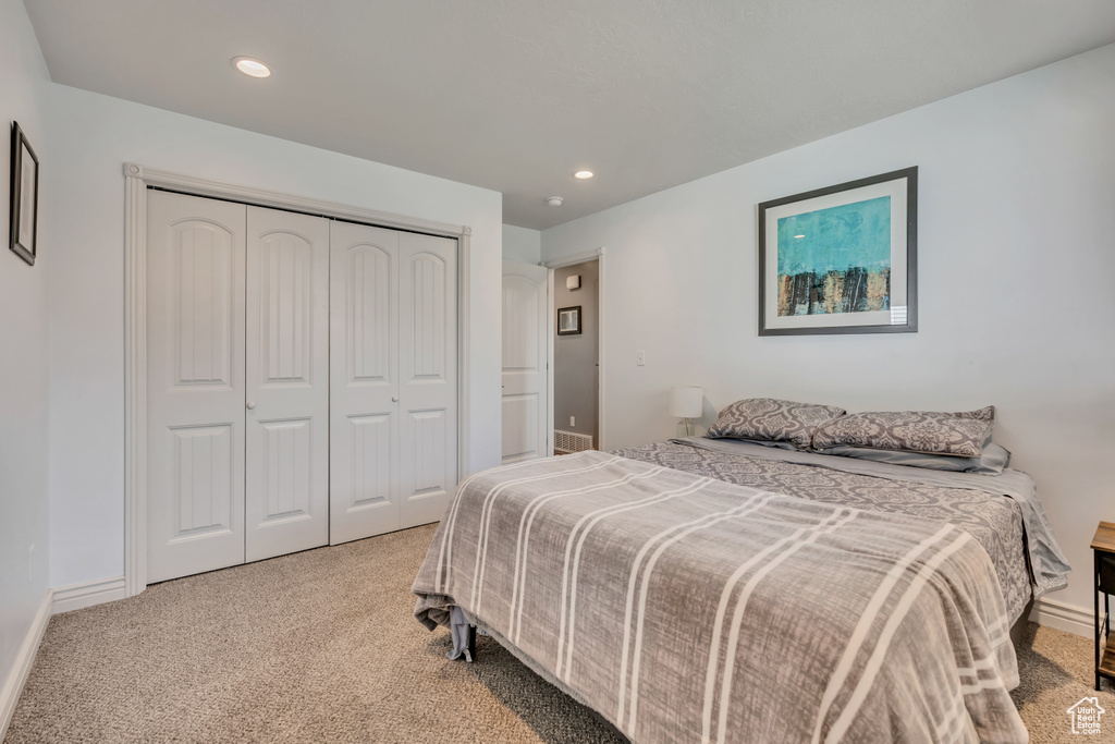 Bedroom with carpet flooring, a closet, and recessed lighting