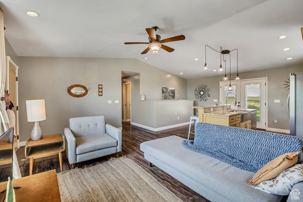 Living room featuring ceiling fan, dark wood-style floors, recessed lighting, and lofted ceiling