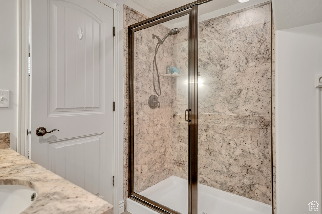 Bathroom featuring a stall shower and vanity
