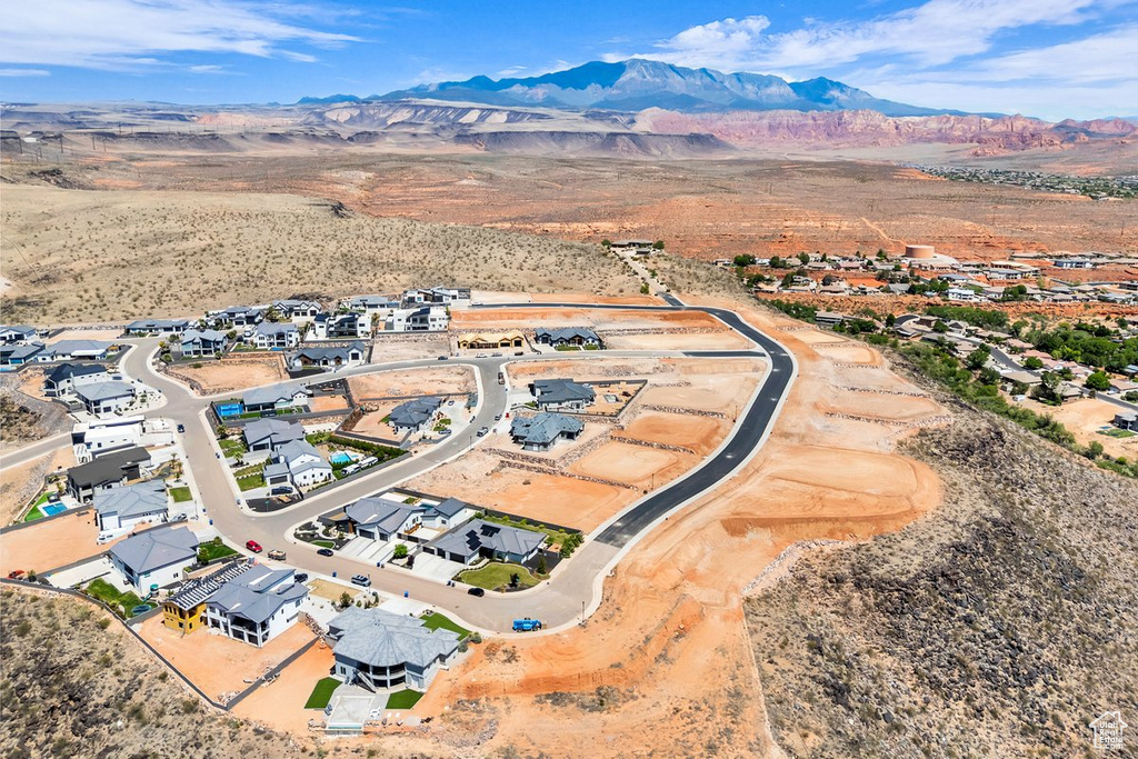 Aerial overview of property\'s location featuring mountains and nearby suburban area