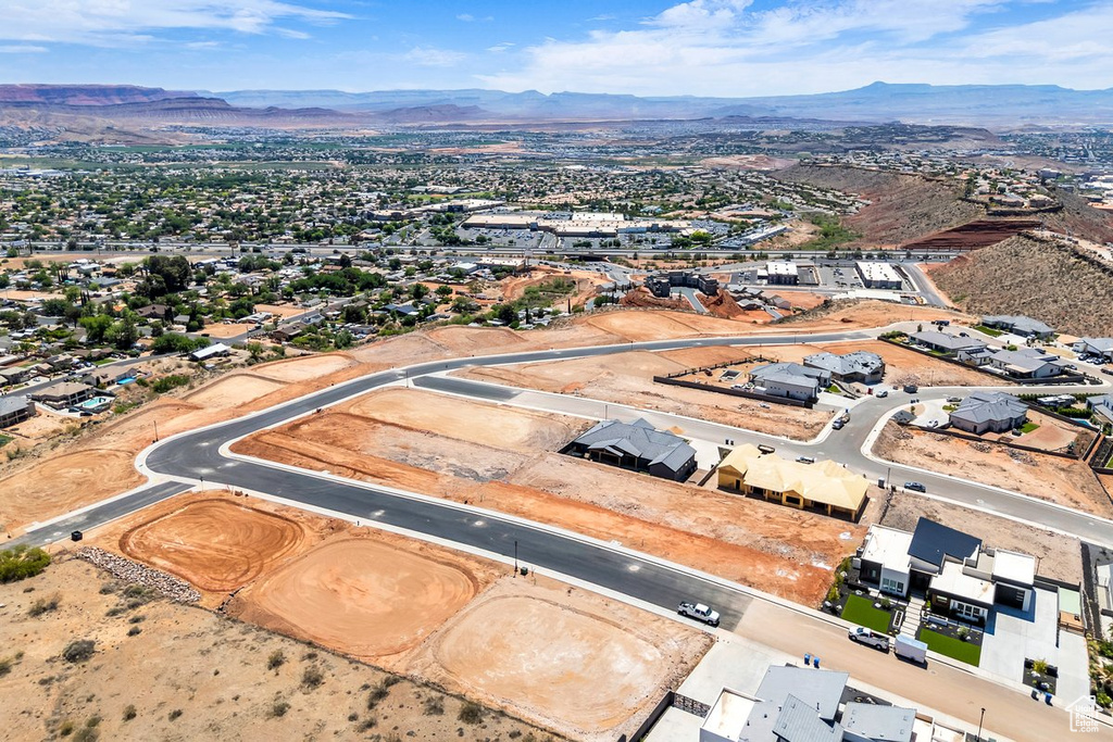 Aerial overview of property\'s location featuring a mountain backdrop and nearby suburban area