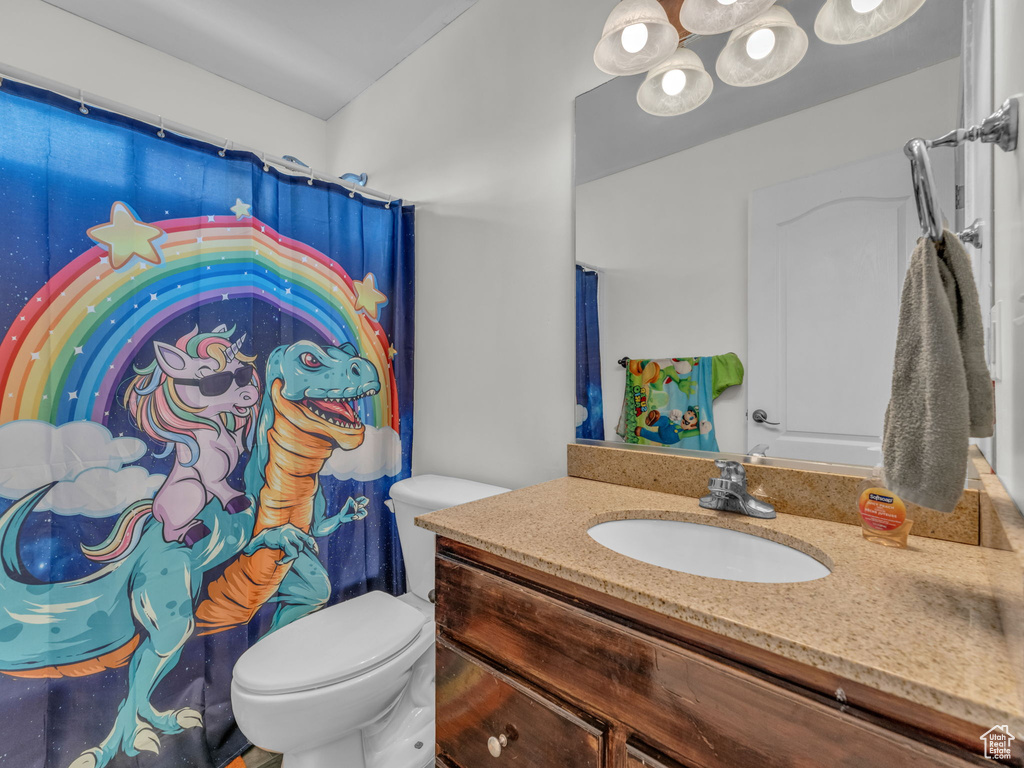 Bathroom with vanity and curtained shower