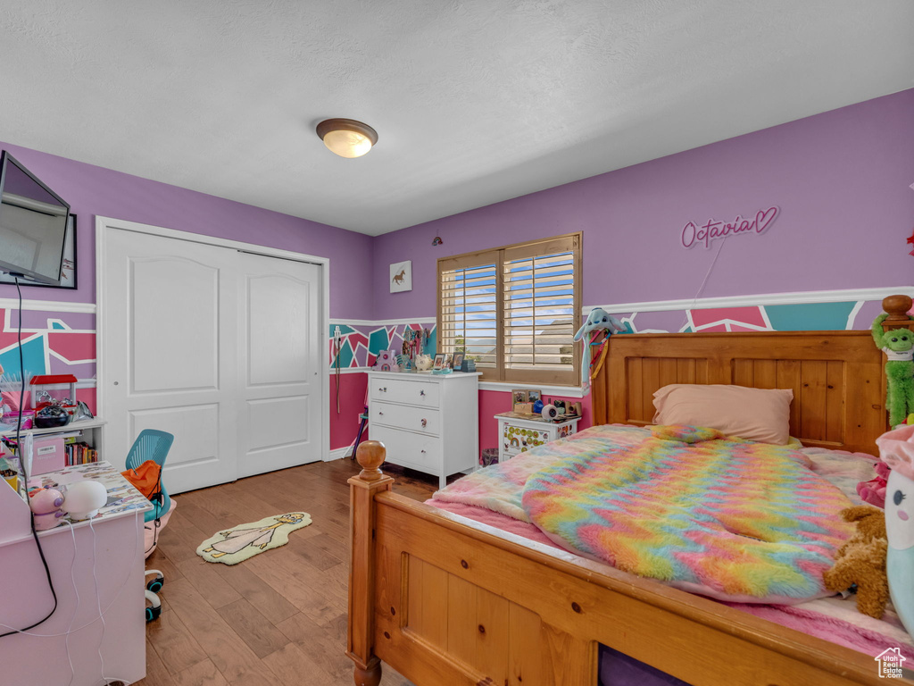 Bedroom with a closet and light wood-type flooring