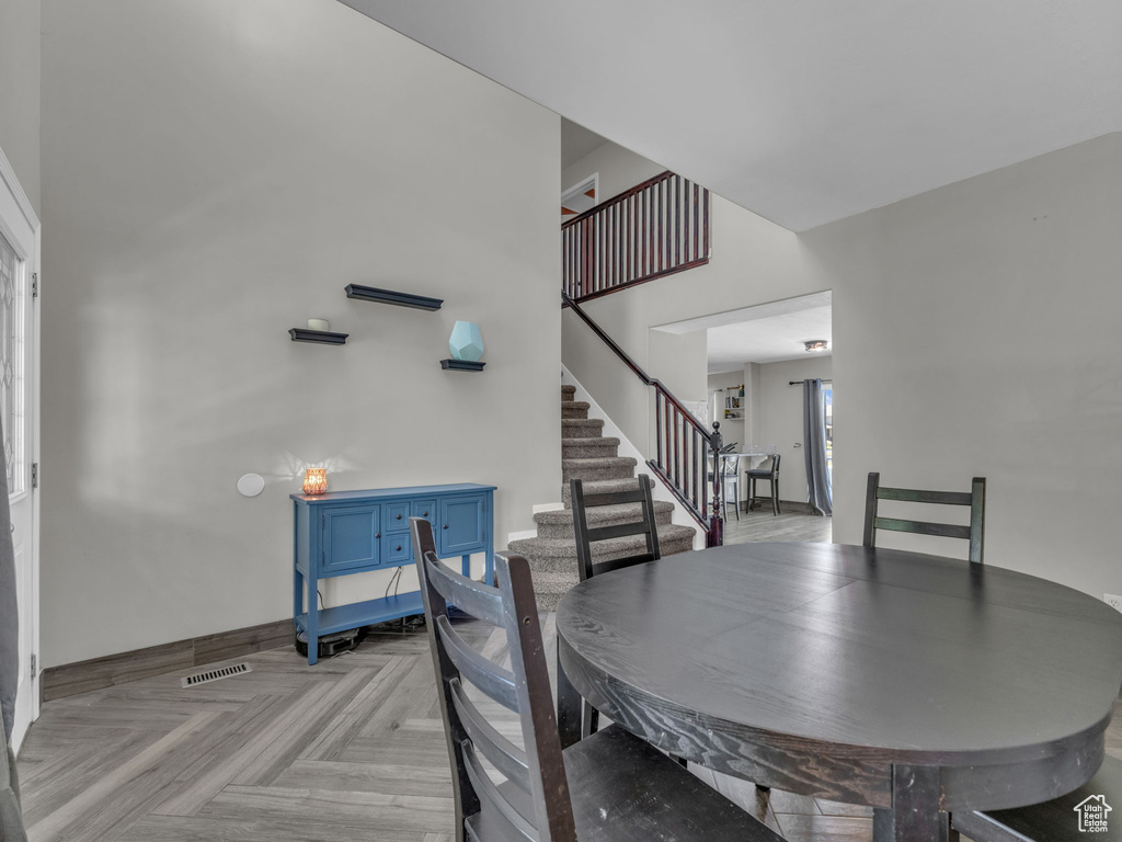 Dining space featuring stairs and baseboards