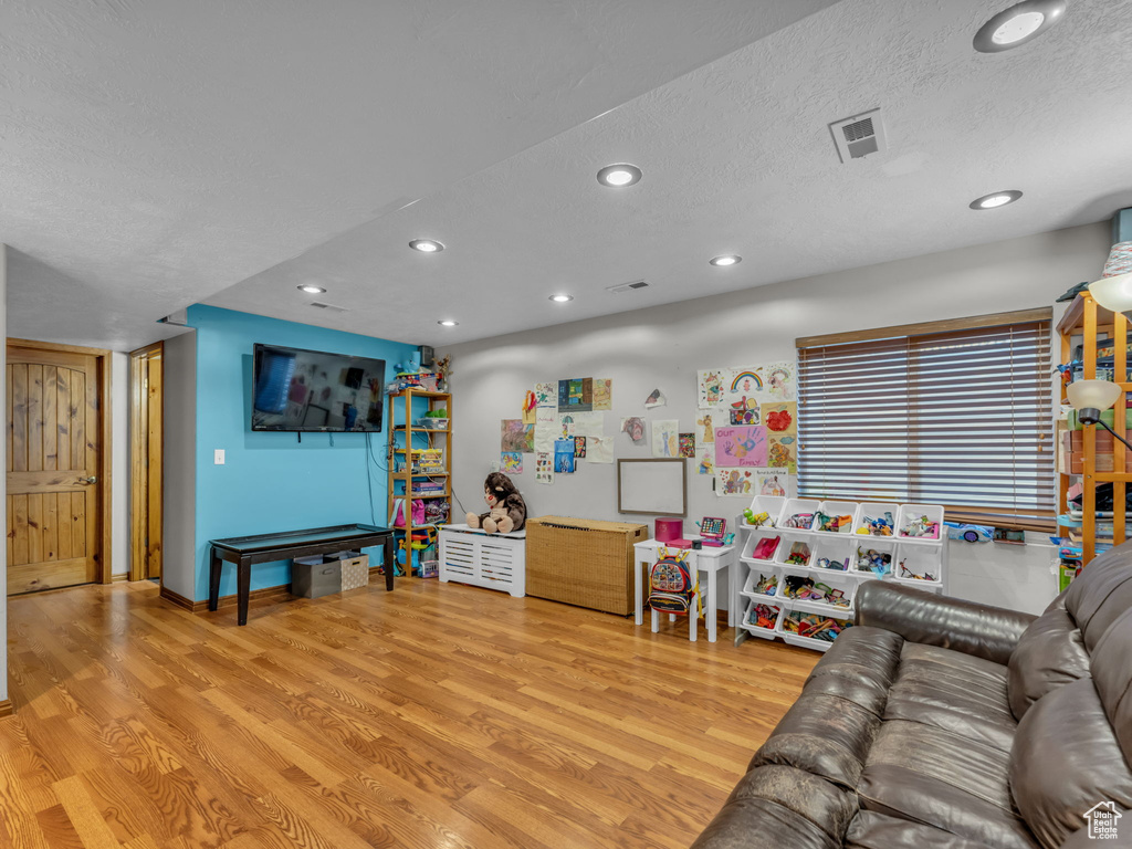 Living room featuring wood finished floors, recessed lighting, and a textured ceiling