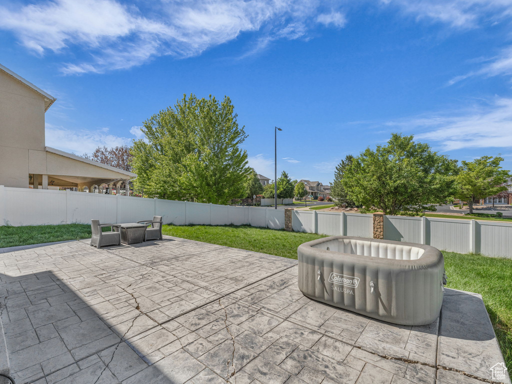 Fenced backyard with a patio area