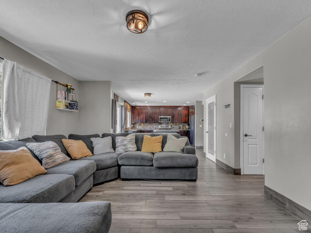 Living room with wood finished floors and a textured ceiling