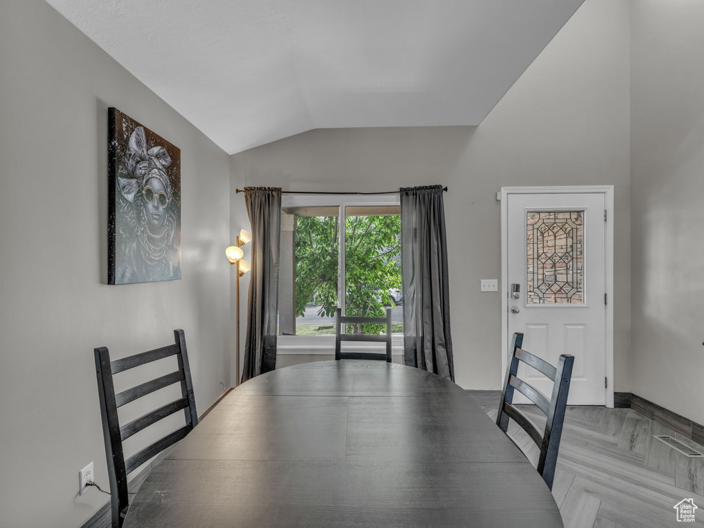 Unfurnished dining area with vaulted ceiling