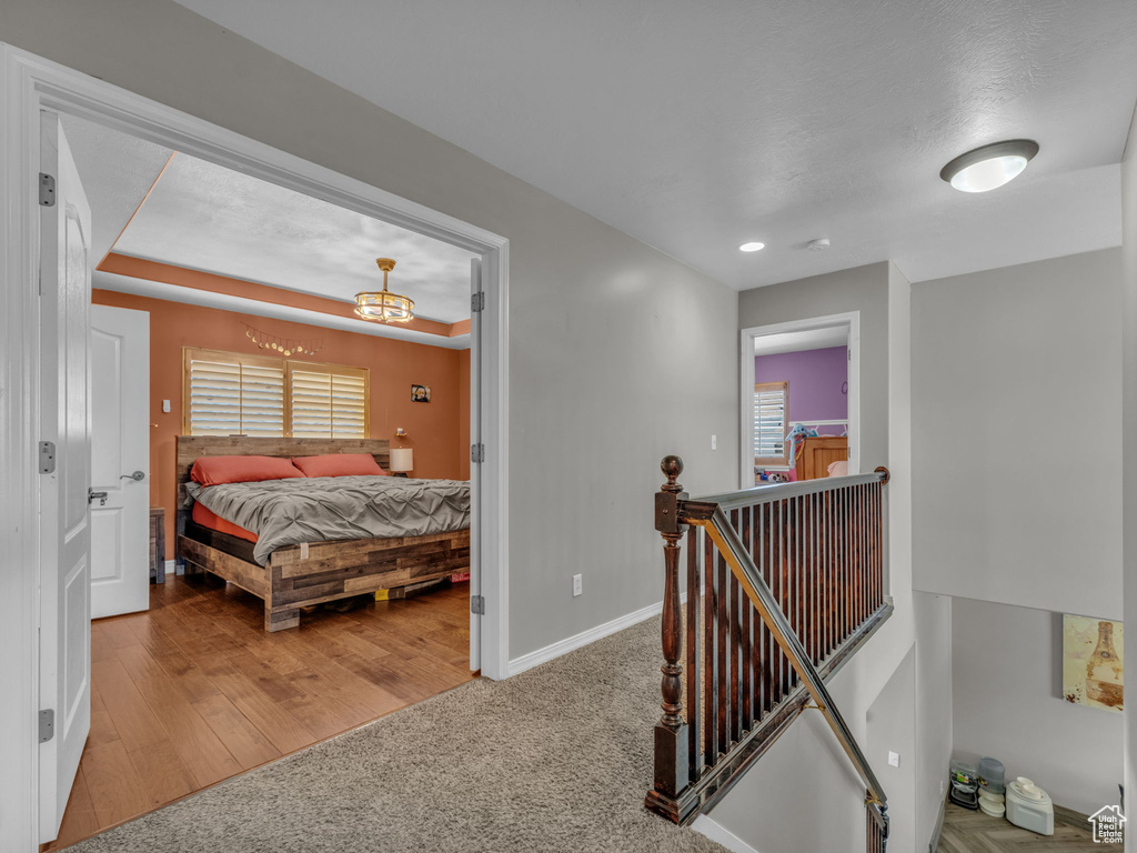 Bedroom with carpet, multiple windows, and a chandelier