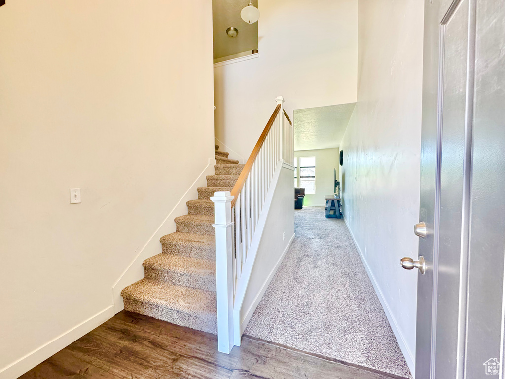 Stairs featuring baseboards and wood finished floors