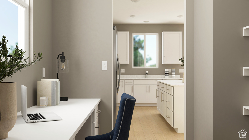 Office area with a sink and light wood-style floors