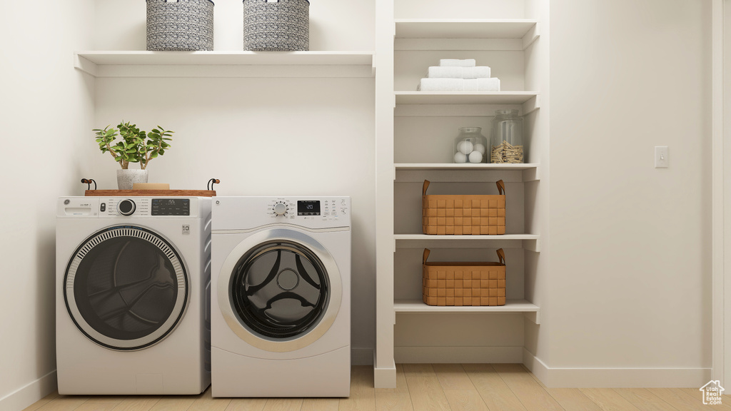 Washroom featuring separate washer and dryer and wood finished floors