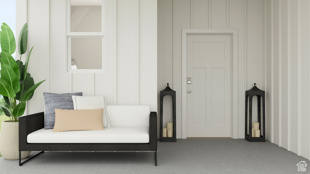 Sitting room featuring a decorative wall and carpet