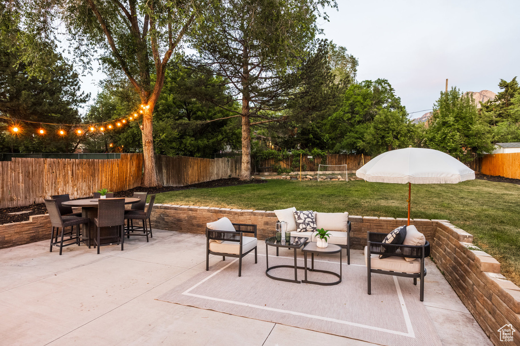 Fenced backyard with a patio, outdoor dining area, and outdoor lounge area