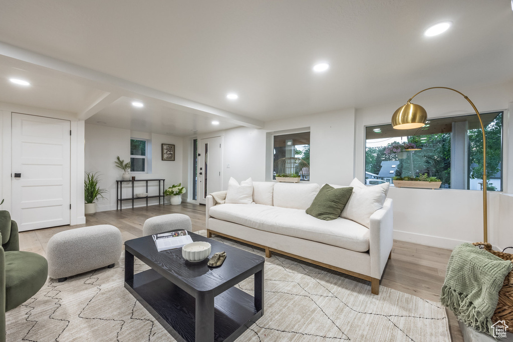 Living room with recessed lighting and light wood-style floors