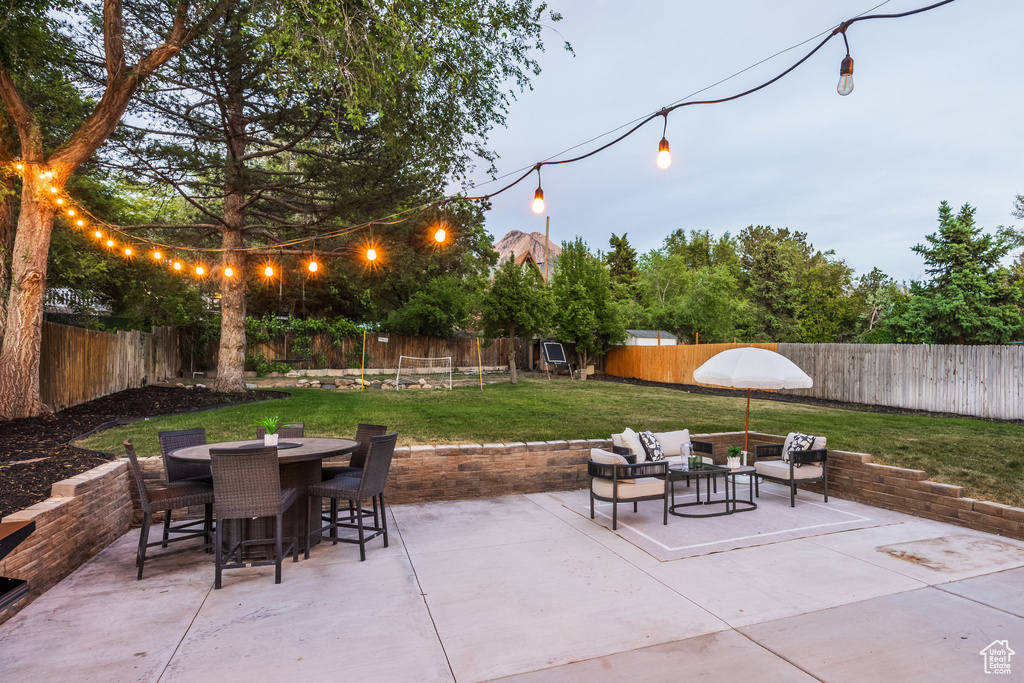 Fenced backyard featuring a patio, outdoor dining space, and an outdoor hangout area