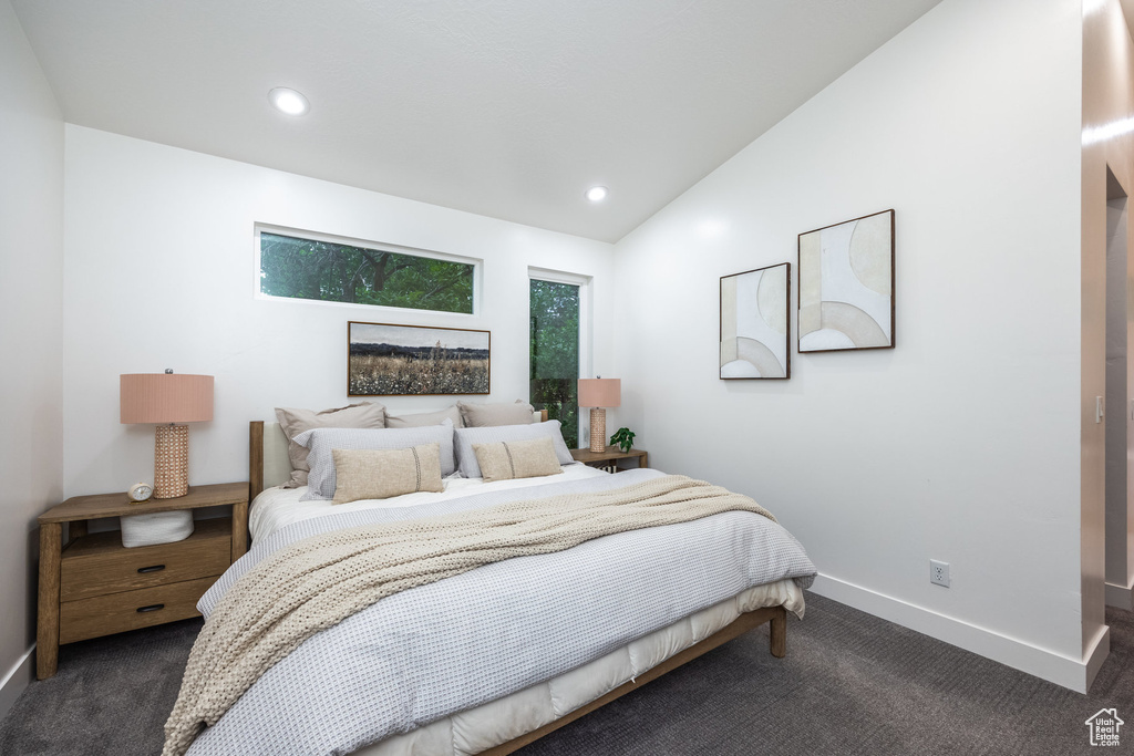 Bedroom featuring dark carpet, vaulted ceiling, and recessed lighting