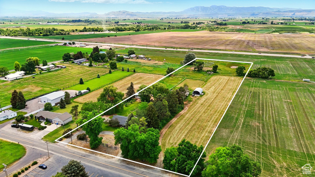 Aerial view of sparsely populated area featuring rows of crops and property parcel outlined