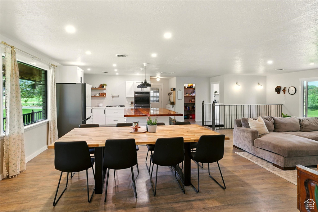 Dining space featuring wood finished floors and recessed lighting