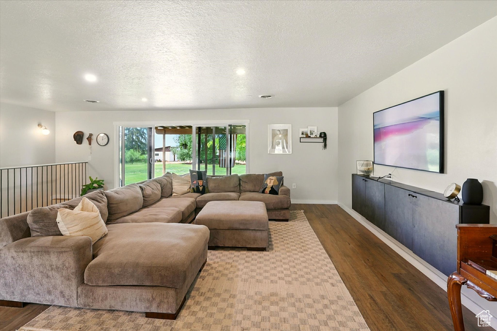 Living area featuring wood finished floors, recessed lighting, and a textured ceiling