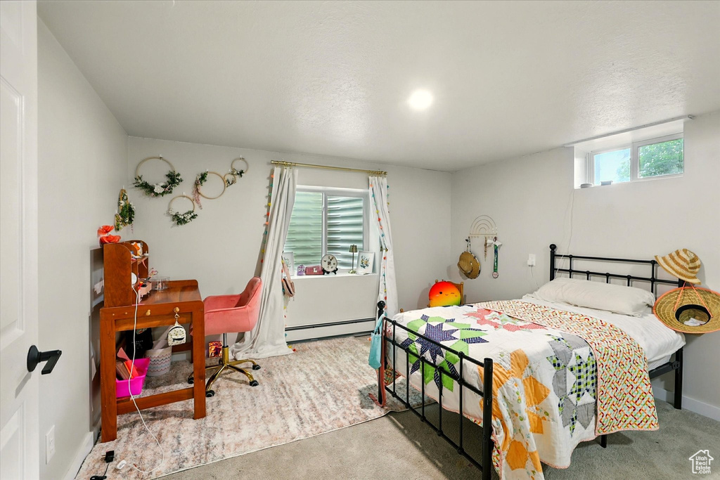 Bedroom featuring a baseboard radiator and carpet