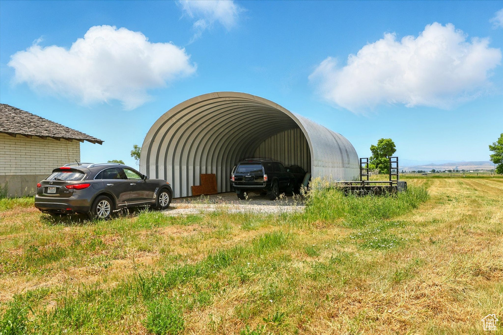 View of parking / parking lot with a detached carport
