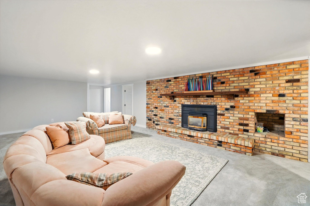 Living room with a fireplace, carpet flooring, and recessed lighting