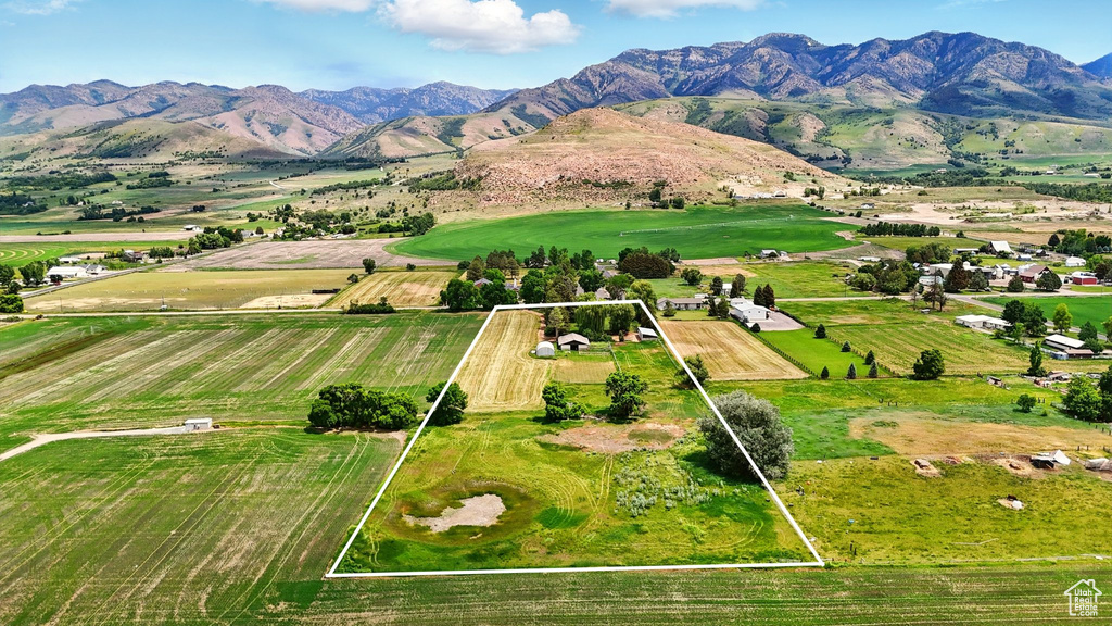 Aerial view of sparsely populated area with property parcel outlined and a mountain backdrop