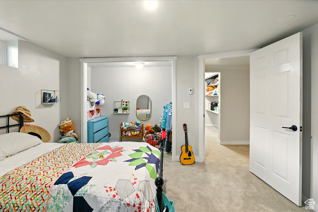 Bedroom featuring light colored carpet and baseboards