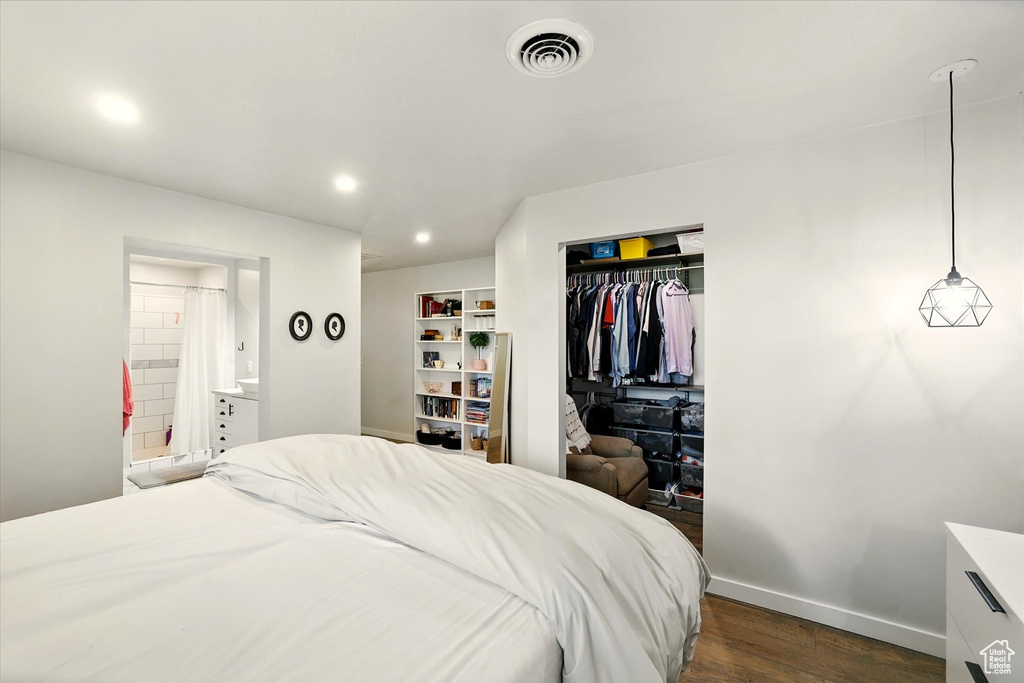 Bedroom with dark wood finished floors, a closet, recessed lighting, and connected bathroom