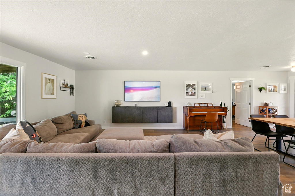 Living area with wood finished floors and recessed lighting