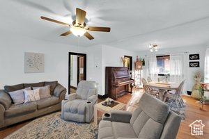 Living room with wood finished floors and ceiling fan