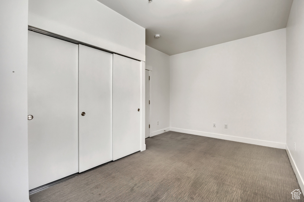 Unfurnished bedroom with carpet floors and a closet