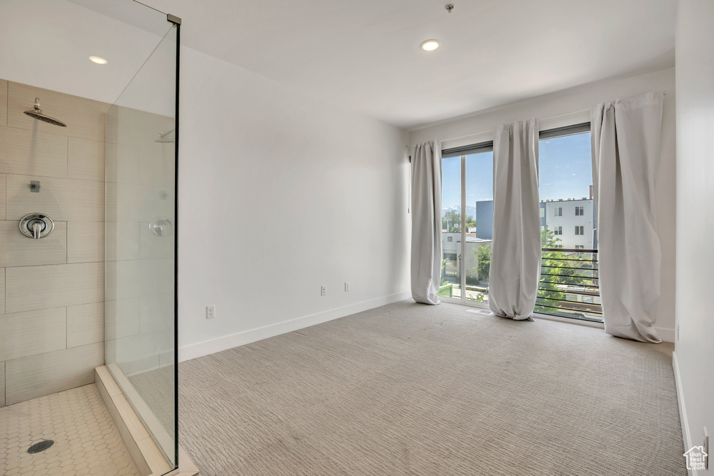 Carpeted empty room with baseboards and recessed lighting