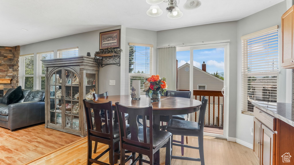 Dining area featuring light wood-type flooring and a chandelier