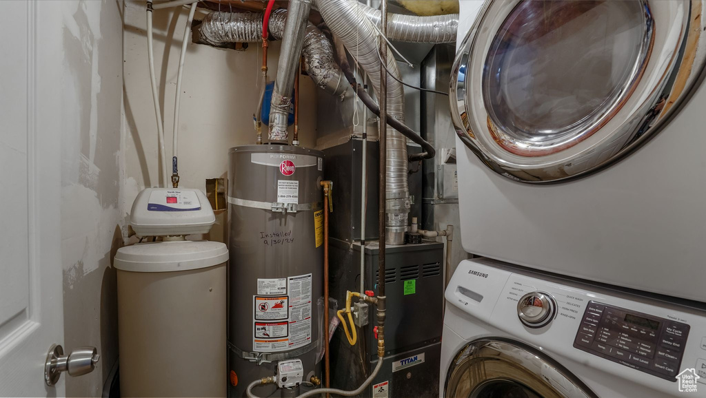 Laundry area with secured water heater and stacked washer / drying machine