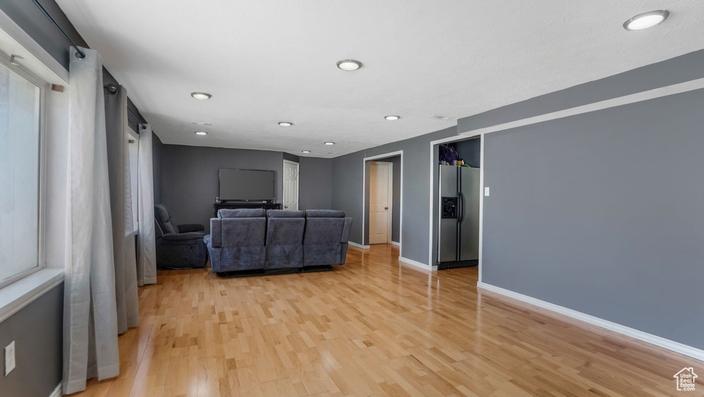 Unfurnished living room with light wood finished floors and recessed lighting