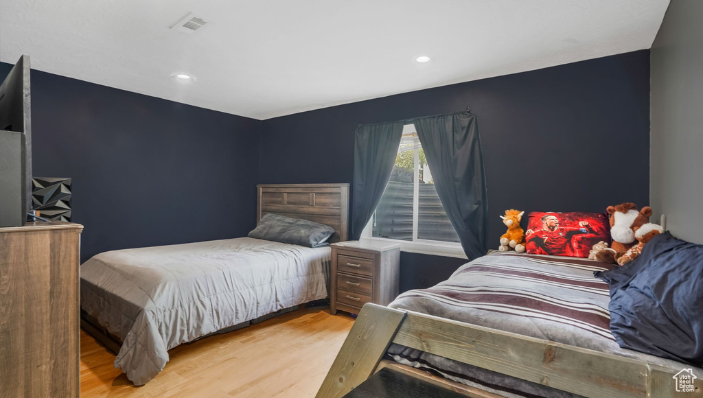 Bedroom with light wood-style floors and recessed lighting