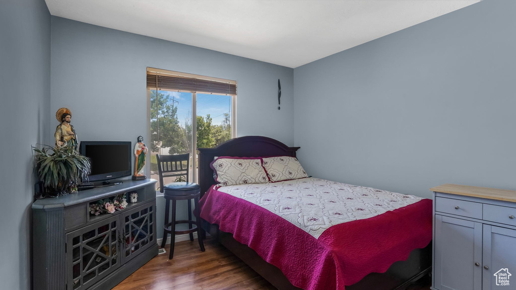 Bedroom featuring access to exterior and wood finished floors