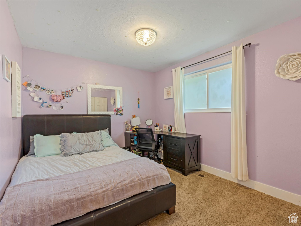 Bedroom with carpet flooring and baseboards