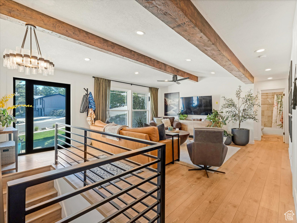 Living area featuring beamed ceiling, recessed lighting, light wood-style floors, and ceiling fan