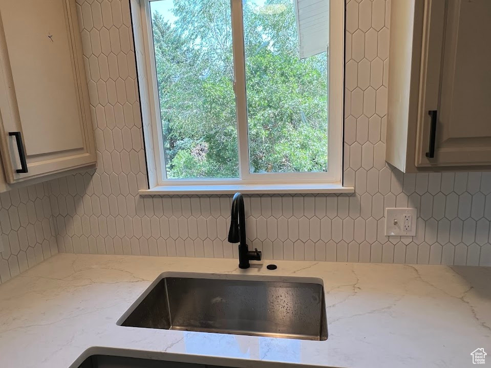 Kitchen view of backsplash and light stone countertops