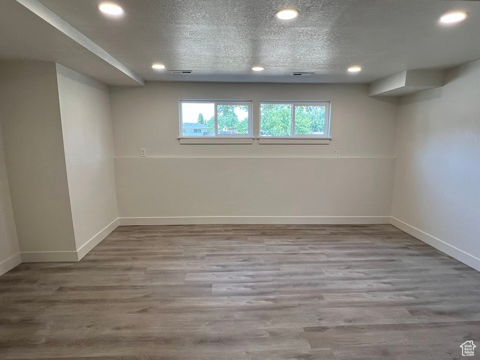 Below grade area featuring recessed lighting and wood finished floors