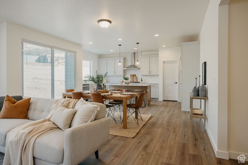 Living area featuring light wood-type flooring and recessed lighting