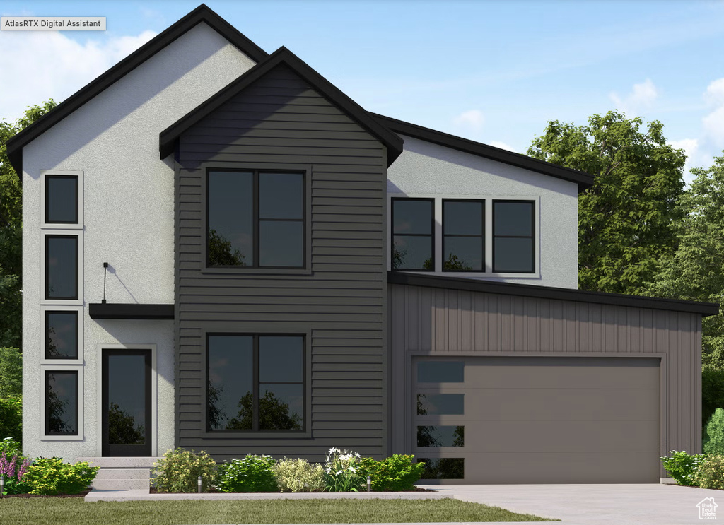 View of front facade with driveway, a garage, and stucco siding