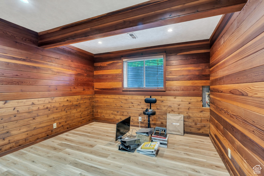 Empty room featuring wood finished floors and wooden walls