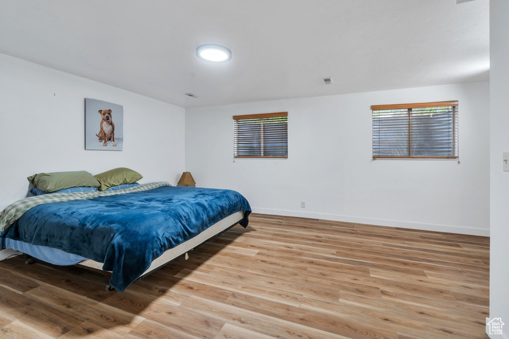 Bedroom featuring light wood-type flooring and baseboards